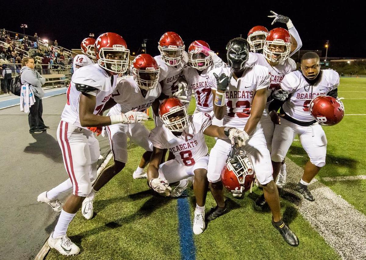 Brookland-Cayce Bearcats players celebrate an interception by Brookland-Cayce Bearcats Dez’Montreon Moore (13), wearing the mask, during the game against the Airport Eagles.