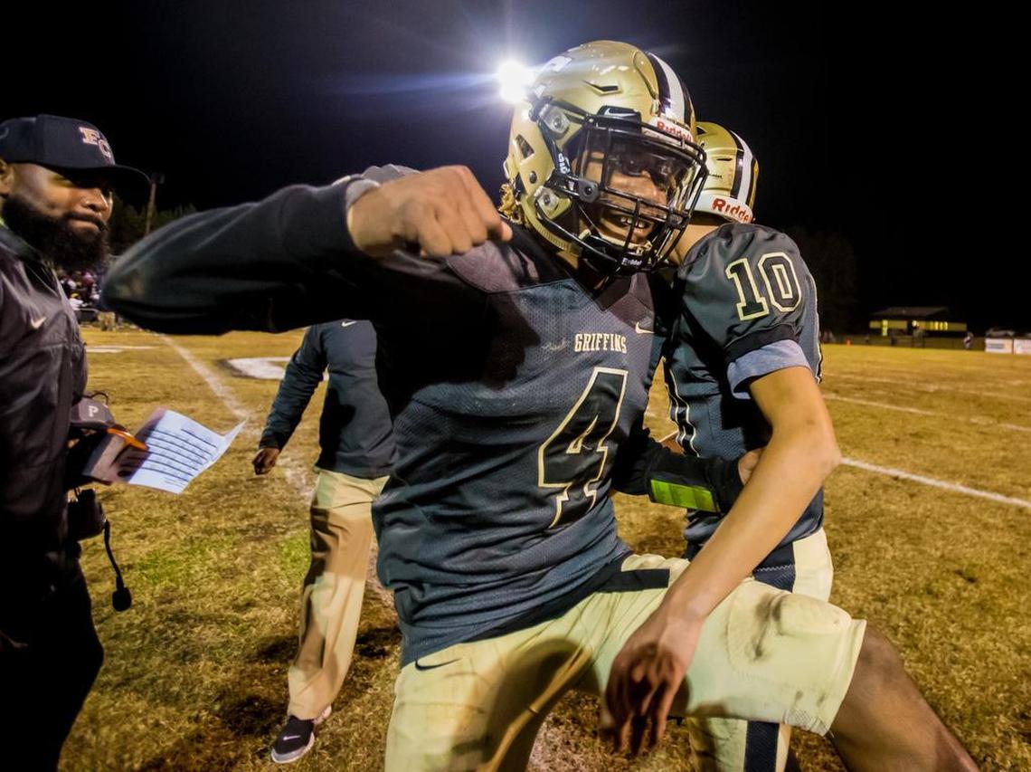 Fairfield Central Griffins Theron Byrd (4) and Fairfield Central Griffins quarterback Jacob McManus (10) celebrate following their 14-7 playoff win over the Newberry Bulldogs.