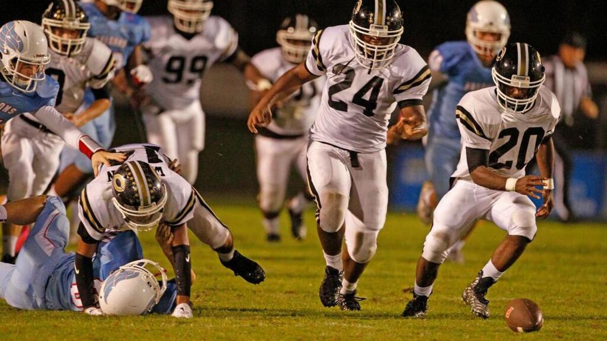 
Camden's Ethan Harris recovers a fumble on a field goal attempt by A.C. Flora at Memorial Stadium on Thursday night. Harris took it back all the way for a touchdown.
