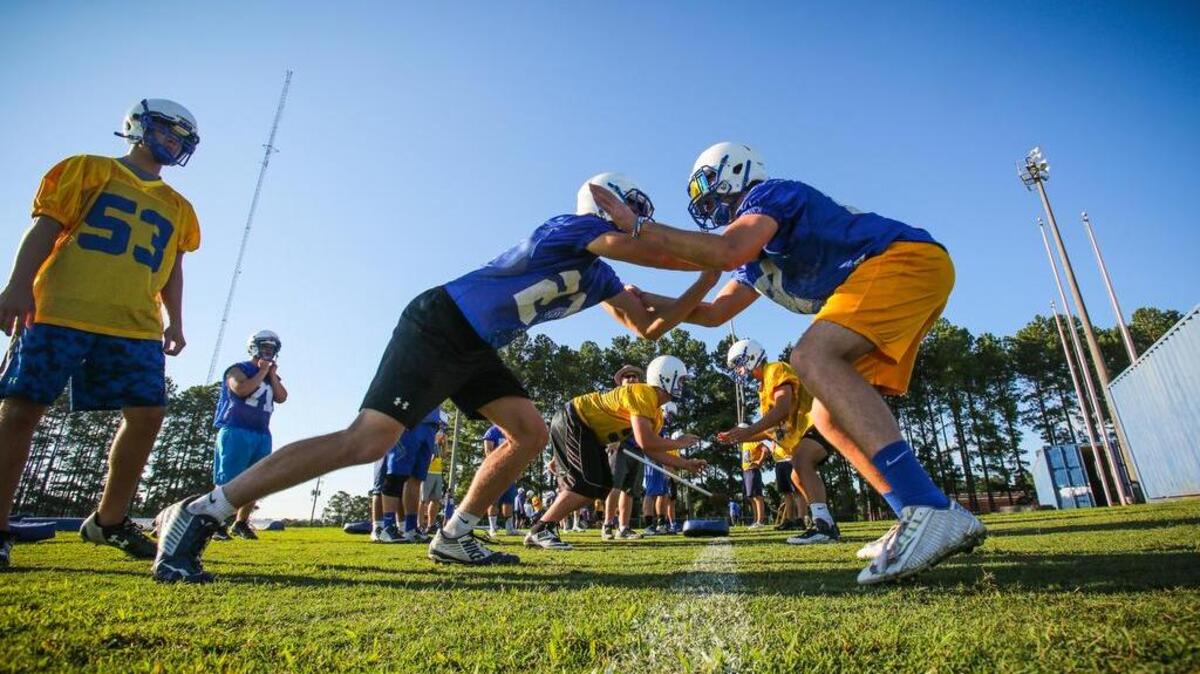 Lexington High’s defensive linemen run through drills.