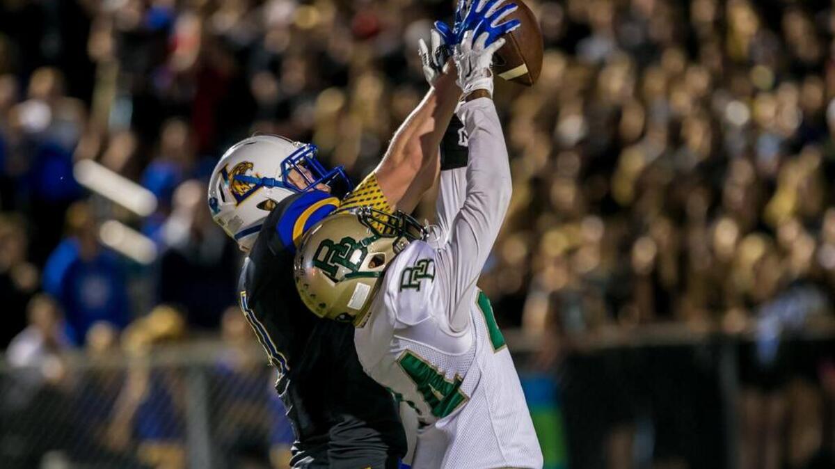 
Lexington's Tyler Schadewald, left, leaps over River Bluff's DJ Ledell to make the touchdown reception during the game between River Bluff High School at Lexington High School. 10/16/15
