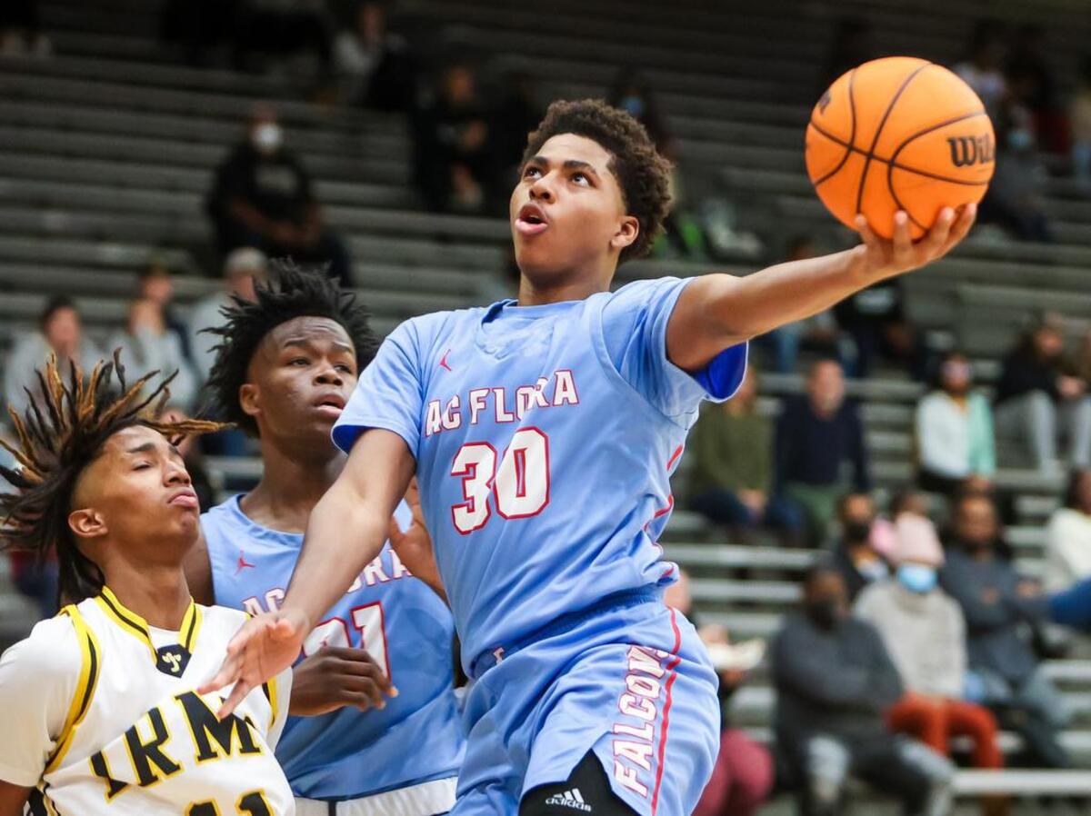 A.C. Flora Falcons Collin Murray-boyles (30) drives past Irmo Yellowjackets guard Javian Green (11) during their game at Irmo High School Friday evening, January 14, 2022.