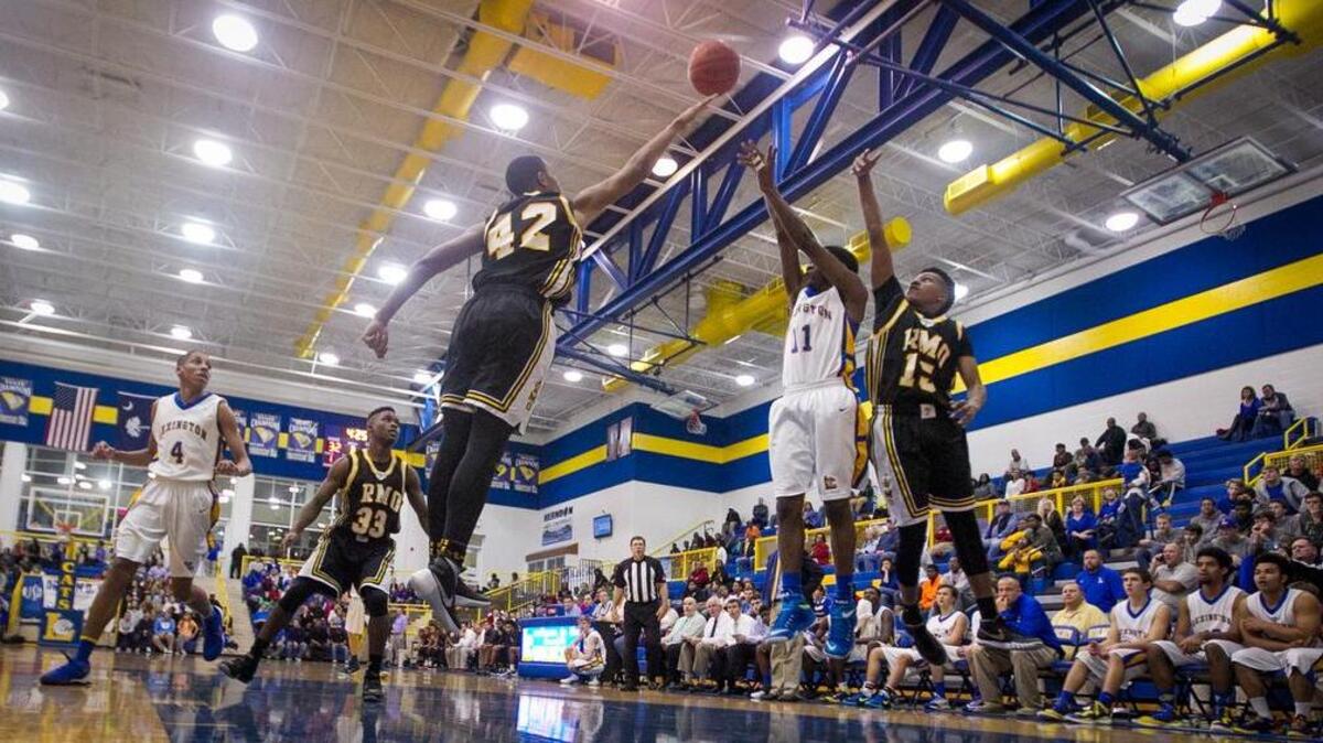 Lexington's Darius Bryant (11) launches a shot over Irmo's Winston Hill (42)