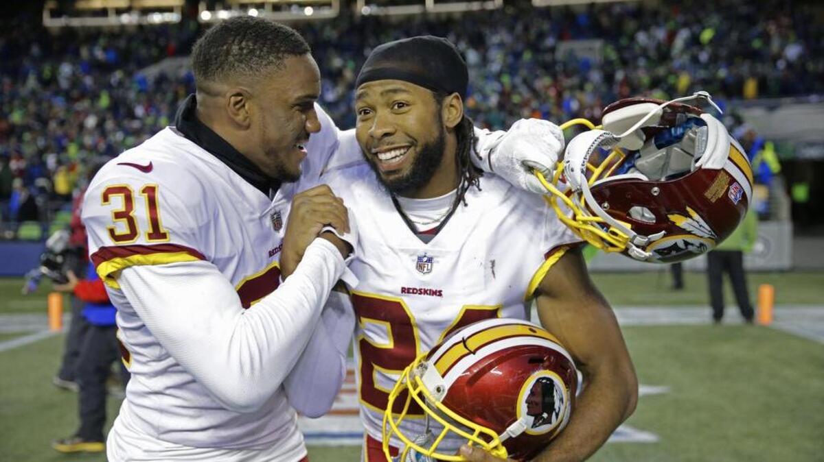 Washington Redskins cornerbacks Josh Norman, right, and Fabian Moreau, left, celebrate after the team’s win over Seattle a few weeks ago.