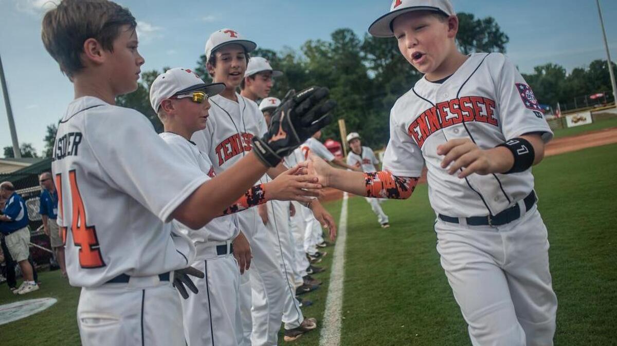 
 FILE PHOTO: High fives exchanged before the Texas vs. Tennessee "O-Zone" game at the 2014 Dixie Youth World Series in Lexington, SC. August , 2014. 
