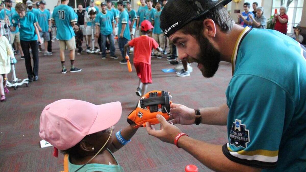 Coastal Carolina’s Anthony Marks talks with a child at Nebraska Medicine during the team’s visit Monday.
