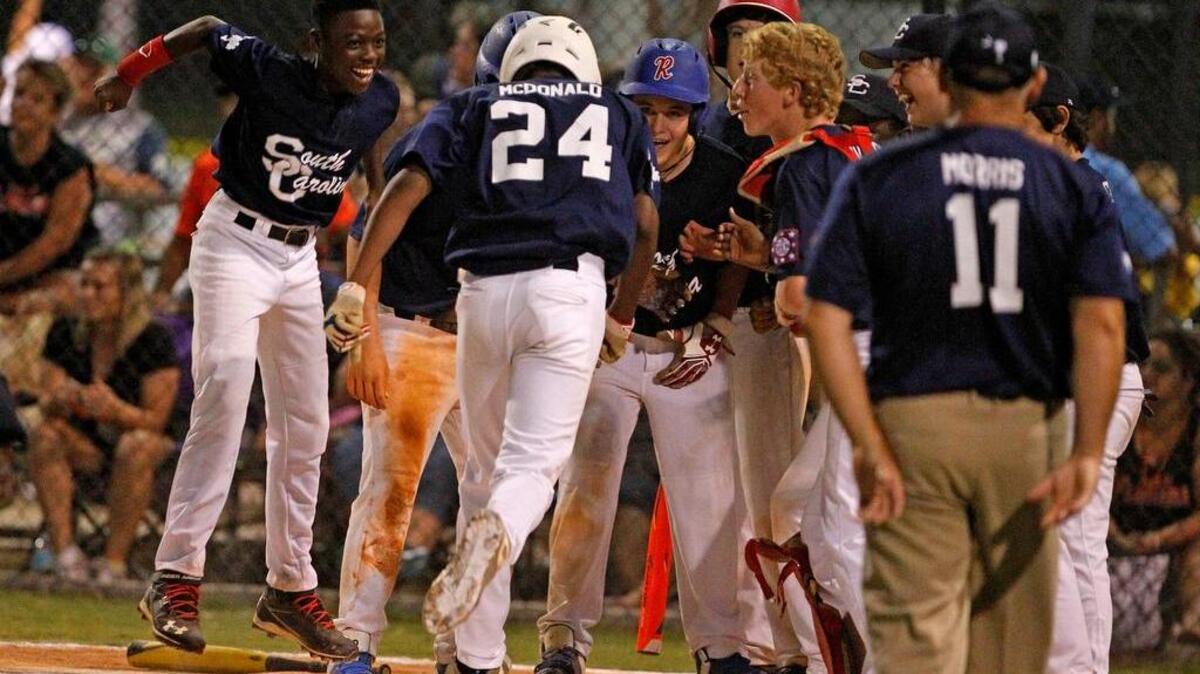 
South Carolina's Keyshawn McDonald celebrates with teammates at home plate after his second home run during their game against Florida in the Dixie Youth World Series in Lexington on Wednesday. The Hartsville team has been dominant throughout the tournament.
