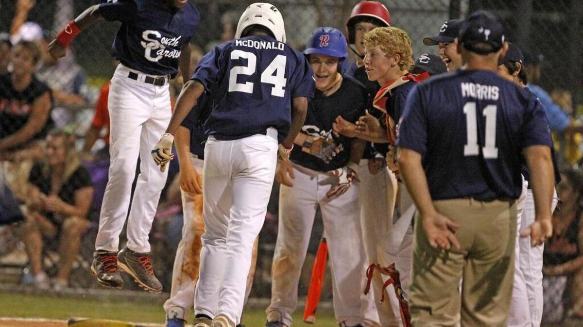 
South Carolina’s Keyshawn McDonald celebrates with teammates at home plate after his second home run against Florida in the Dixie Youth World Series in Lexington on Wednesday night.
