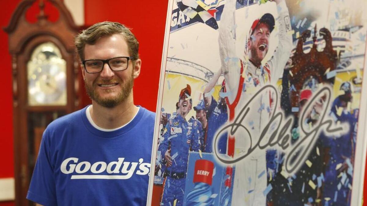 Dale Earnhardt Jr. poses with a mock-up of a trading card during a news conference at Martinsville (Va.) Speedway on Sunday. He was promoting Goody’s products.