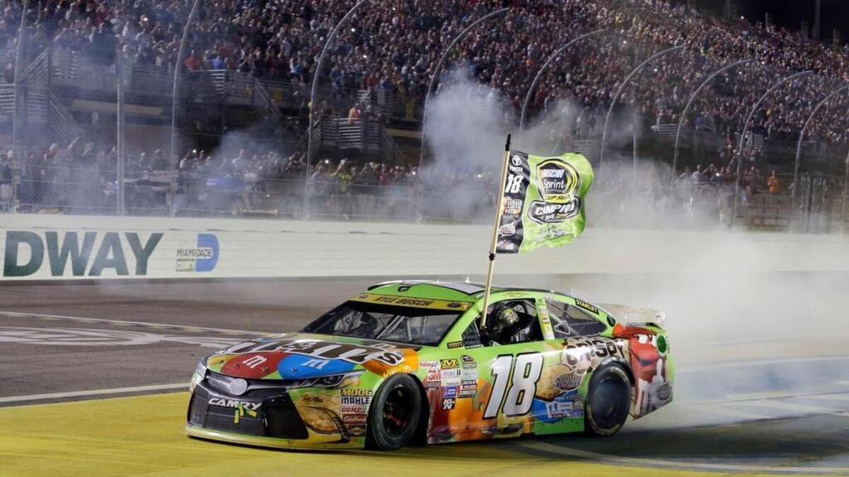 Kyle Busch celebrates after winning the NASCAR Sprint Cup Series auto race and the season title, Sunday, Nov. 22, 2015, at Homestead-Miami Speedway in Homestead, Fla. (AP Photo/Terry Renna)