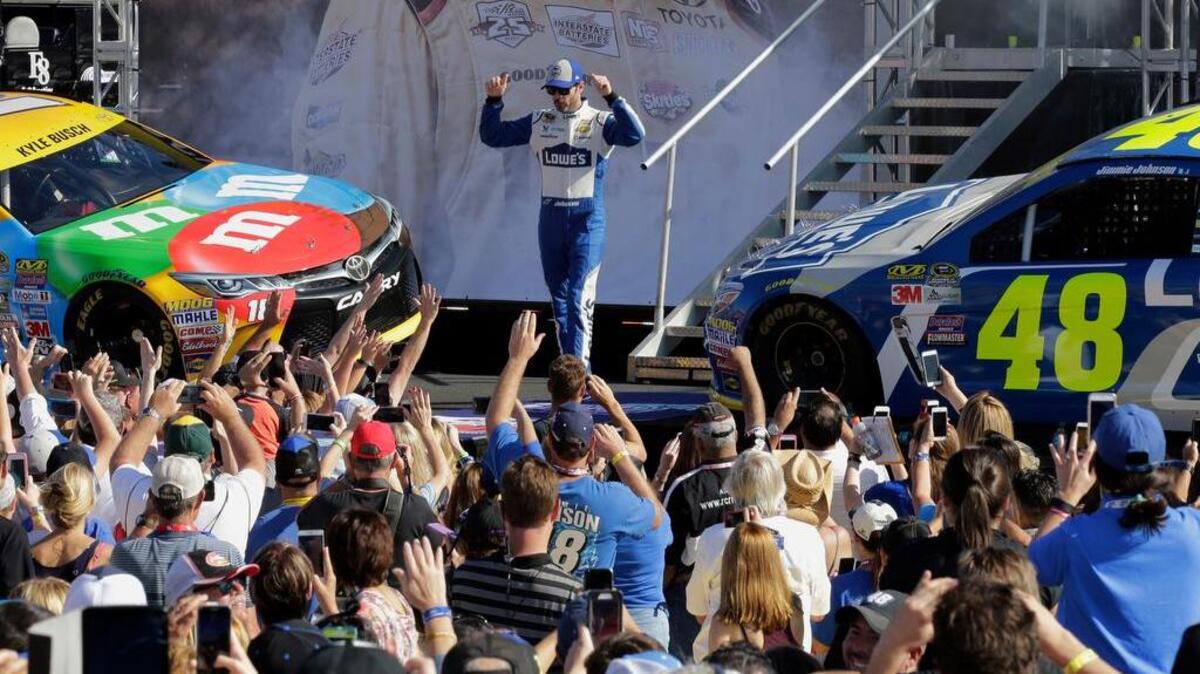 Jimmie Johnson responds to fans as he greets them during driver introduction before the NASCAR Sprint Cup auto race Sunday, Nov. 20, 2016, in Homestead, Fla.