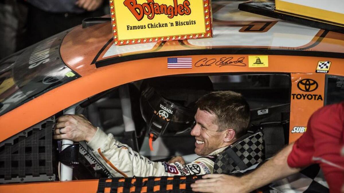 Carl Edwards smiles in the winner’s circle after capturing the checkered flag in the Southern 500 in 2015.
