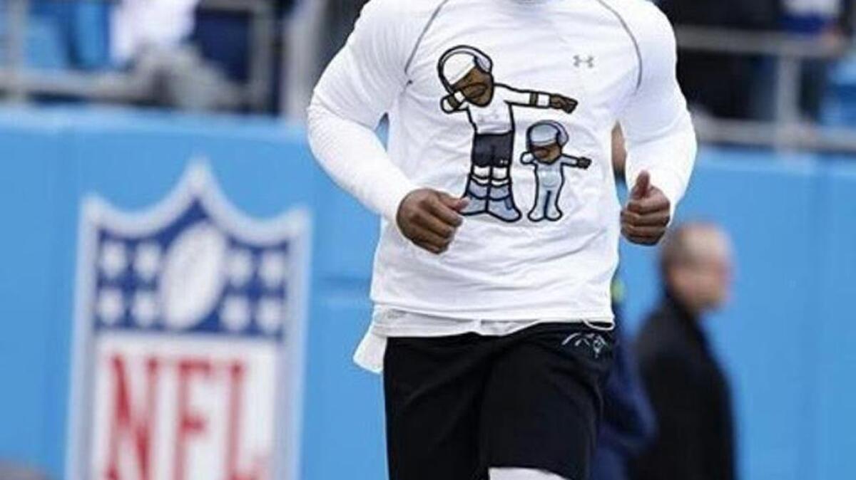 Cam Newton warms up Sunday before the playoff game in Charlotte against the Seattle Seahawks. The design by a Charlotte company is getting loads of attention.