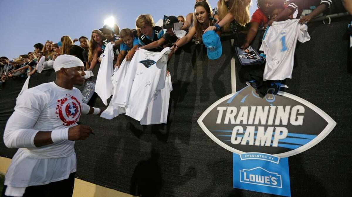 
Carolina’s Cam Newton signs autographs after practice during the team’s training camp in Spartanburg.
