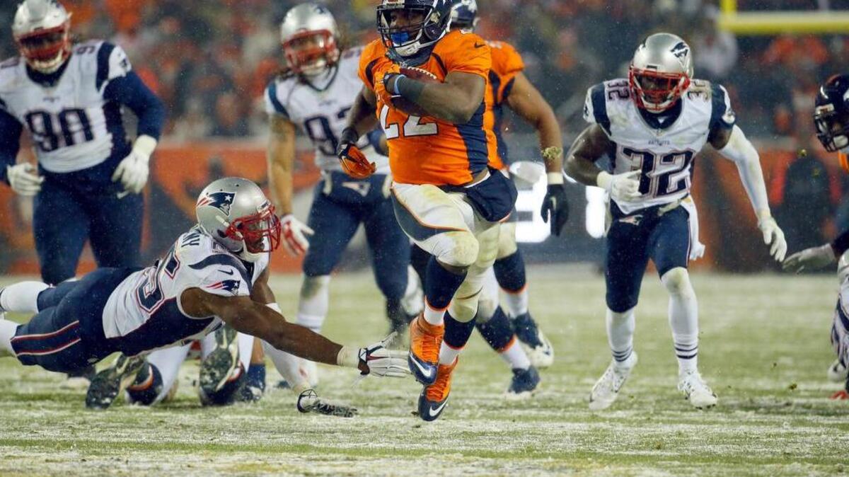Denver Broncos running back C.J. Anderson (22) breaks free for the game-winning touchdown against the New England Patriots during overtime of an NFL football game, Sunday, Nov. 29, 2015, in Denver. The Broncos defeated the Patriots 30-24.