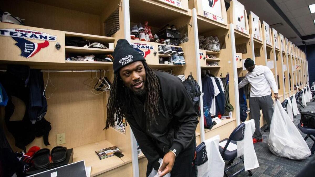 Houston Texans linebackers Jadeveon Clowney, left, and Whitney Mercilus clean out their lockers at NRG Stadium after being eliminated from the playoffs, Sunday, Jan. 10, 2016, in Houston.