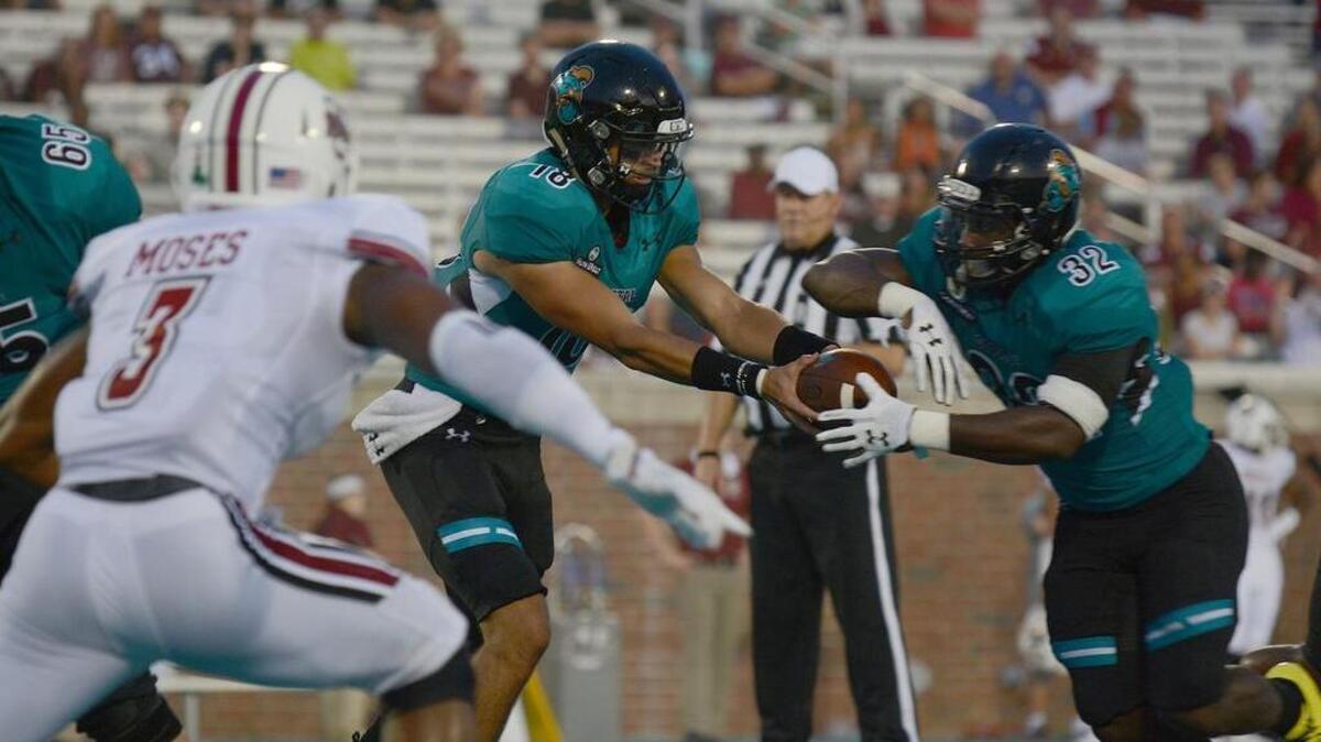 Coastal Carolina quarterback Dalton Demos and running back Osharmar Abercrombie.