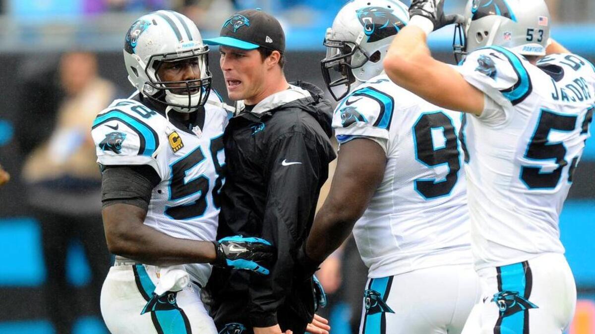 
Carolina Panthers' Luke Kuechly congratulates Thomas Davis Sr. (58) after a defensive series against the New Orleans Saints. 
