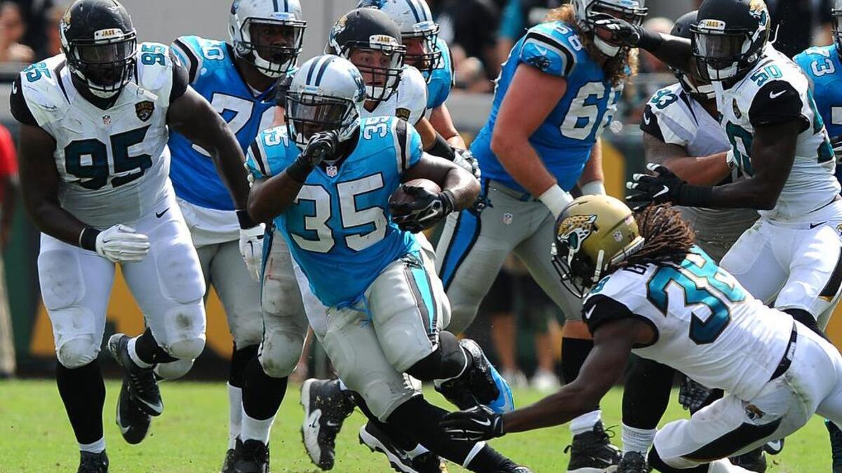 
Carolina Panthers full back Mike Tolbert breaks to midfield for yardage as the Jacksonville Jaguars defense gives chase during fourth quarter action at EverBank Field in Jacksonville, Florida, on Sunday, September 13, 2015. The Panthers are valued at $1.56 billion by Forbes magazine. 
