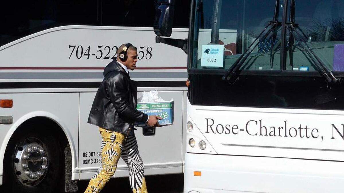Carolina Panthers quarterback Cam Newton boards a bus bound for the Charlotte airport at Bank of America Stadium.