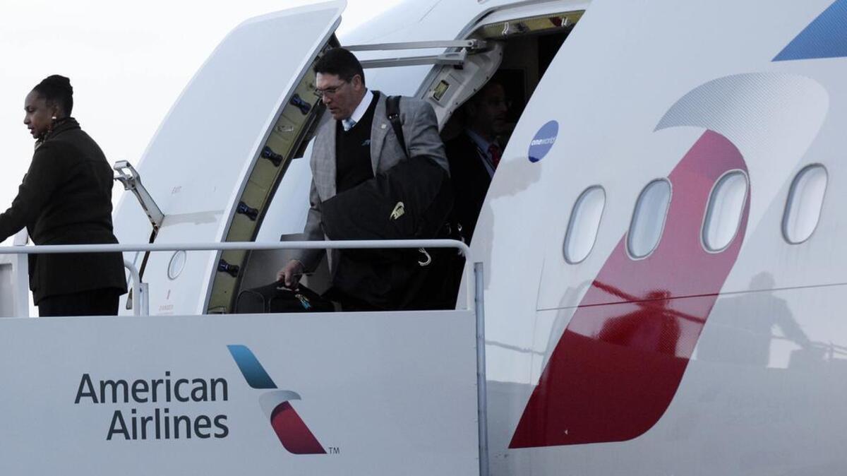 Carolina Panthers head coach Ron Rivera deplanes after landing at Mineta San Jose International Airport on Sunday for Super Bowl 50.