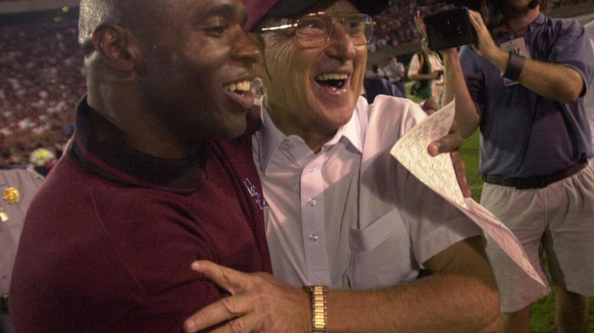 USC head coach Lou Holtz and defensive coach Charlie Strong congratulate each other after the Gamecocks beat the Georgia Bulldogs in Athens, Ga., Sept. 9, 2001.