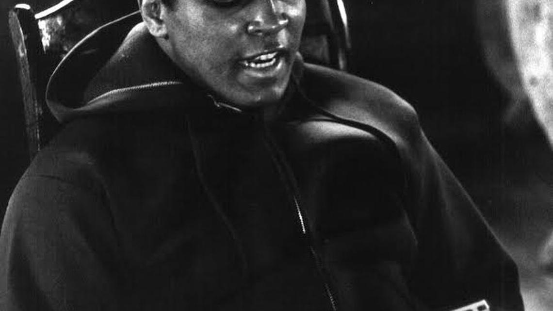 Muhammad Ali recites his poems into Manuel Gaetan’s tape recorder at Ali’s Pennsylvania training camp in 1973.